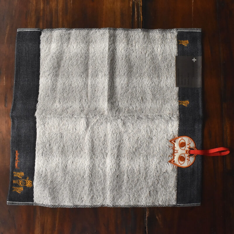 オレンジ顔のミミケルレロレロ紐付き今治タオル