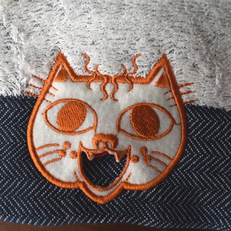 オレンジ顔のミミケルレロレロ紐付き今治タオル