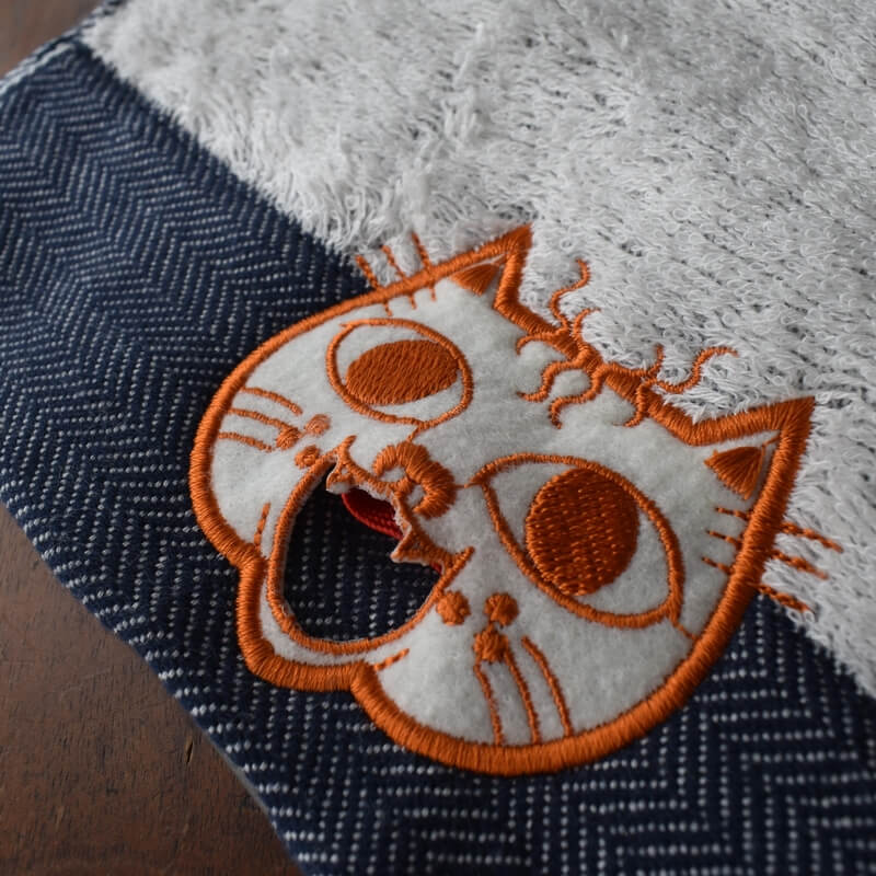 オレンジ顔のミミケルレロレロ紐付き今治タオル