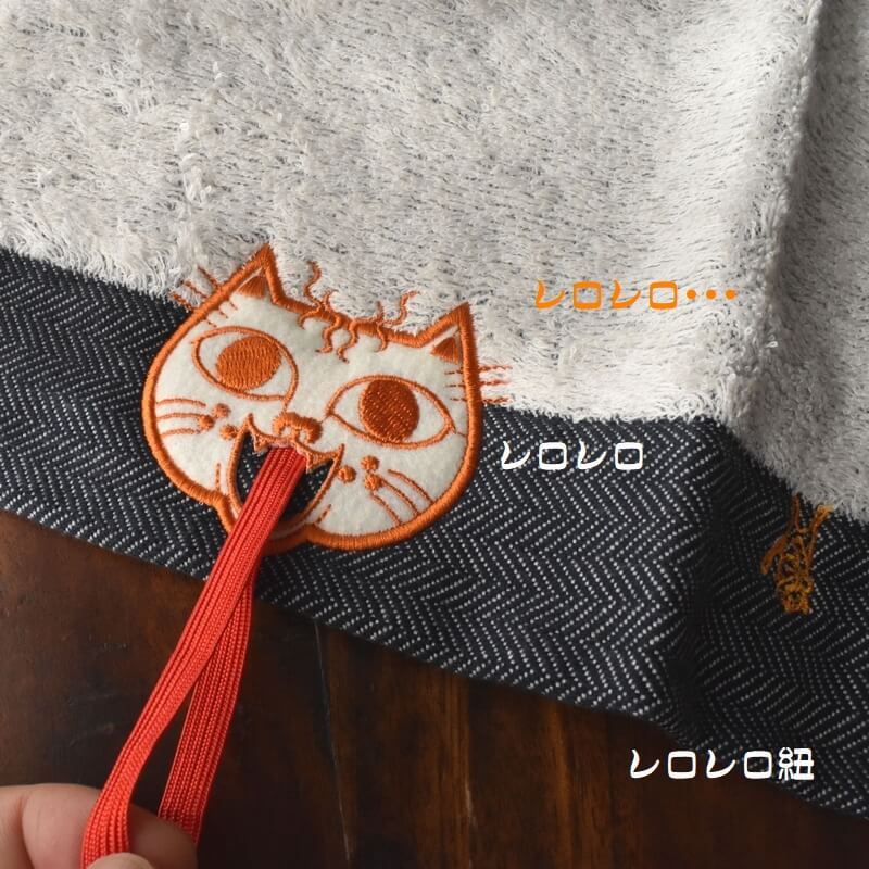 オレンジ顔のミミケルレロレロ紐付き今治タオル